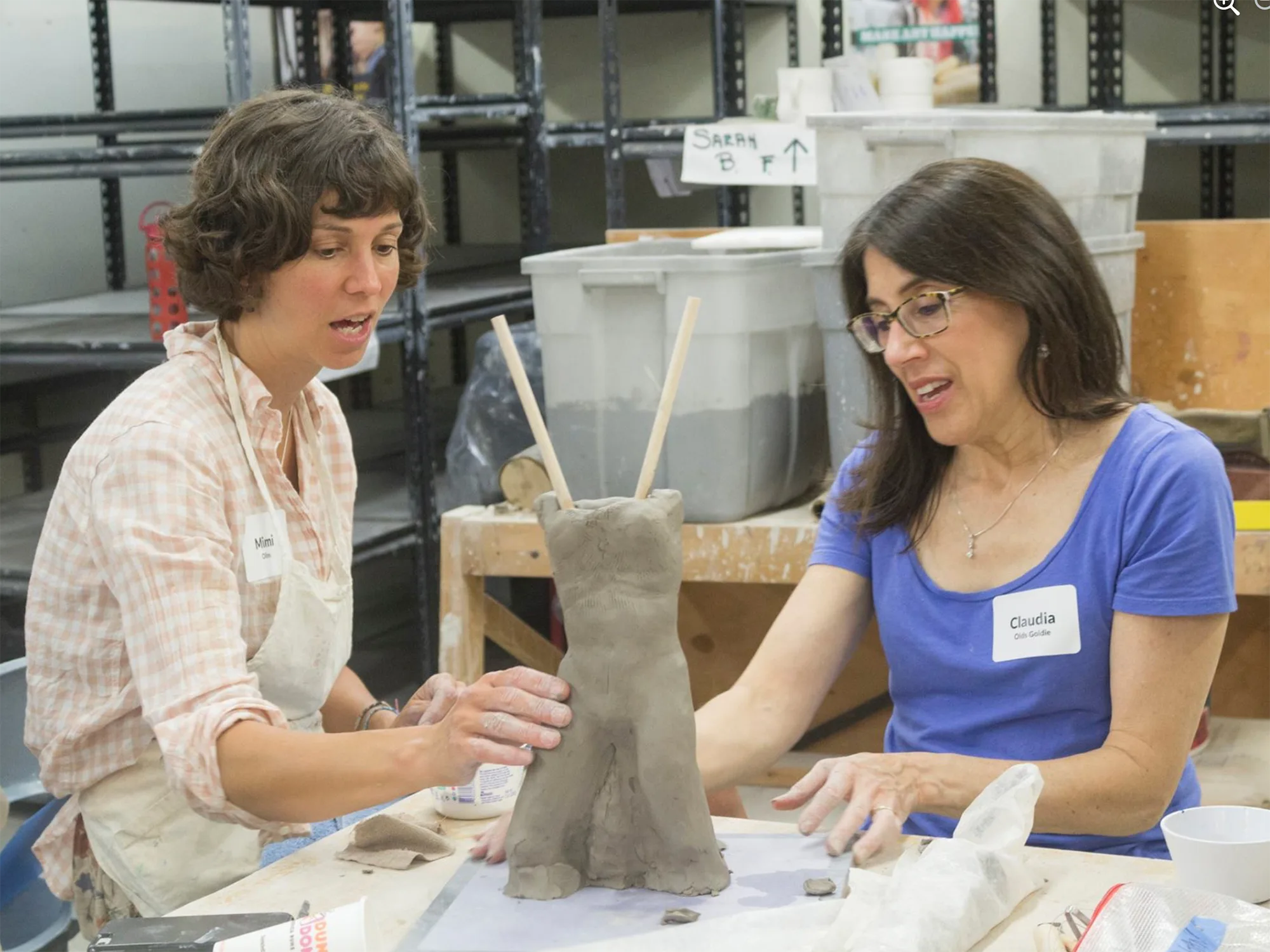 Claudia Olds Goldie working with a student on a clay figure