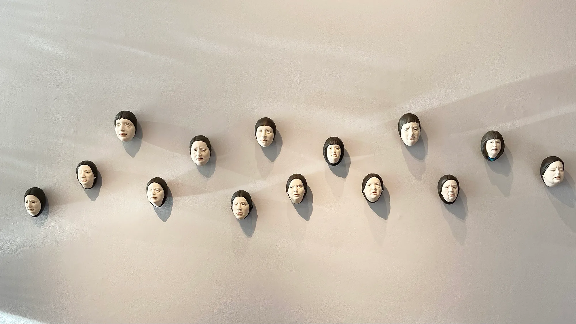 Chorus of Eggheads — ceramic installation by Claudia Olds Goldie